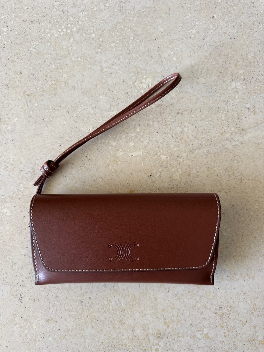 CELINE. Brown Leather Wristlet Clutch with Embossed Logo Accent